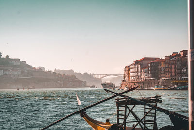 View of buildings by sea against clear sky