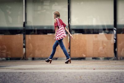 Full length of girl walking on street