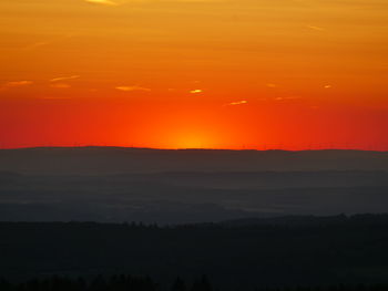 Scenic view of silhouette landscape against romantic sky at sunset