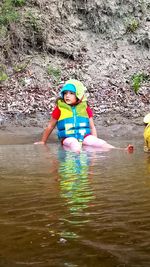 Full length portrait of boy in water