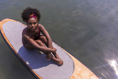 Portrait of smiling young woman in swimming pool