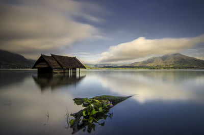 Scenic view of lake by buildings against sky