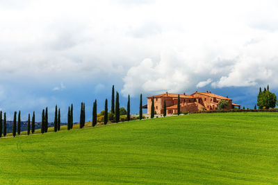 Panoramic view of castle on field against cloudy sky