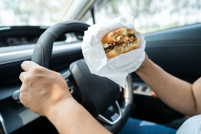 Cropped hand of man holding food