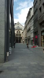 Buildings in city against cloudy sky