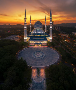 High angle view of illuminated buildings against sky during sunset