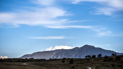 Scenic view of landscape and mountains against sky