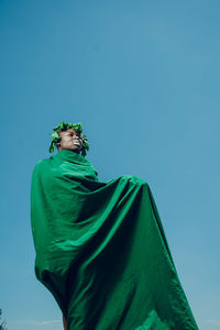 Low angle view of statue against blue sky