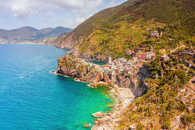 Scenic view of sea and mountains against sky