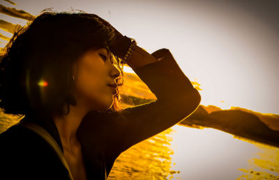 Portrait of woman looking at sunset