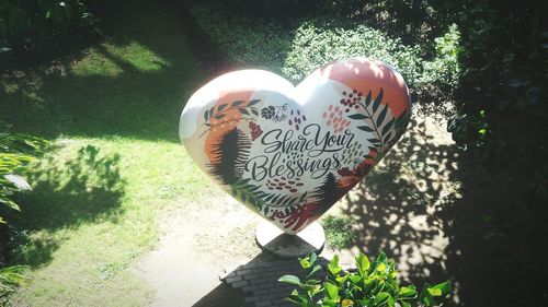 Close-up of heart shape with text on tree