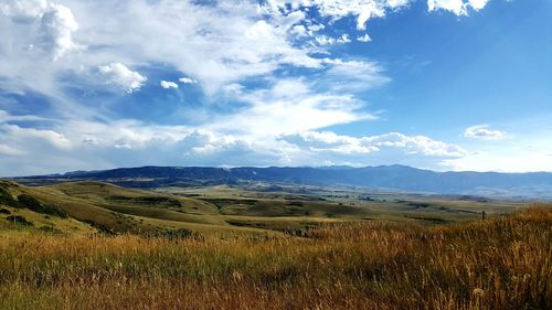 Scenic view of landscape against cloudy sky