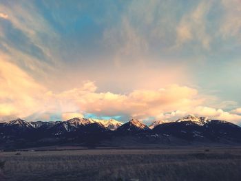 Scenic view of mountains against cloudy sky