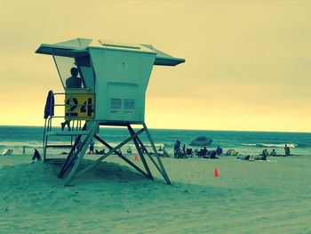 Lifeguard hut on beach against sky