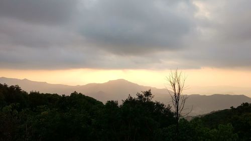 Scenic view of mountains against sky at sunset