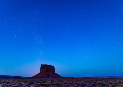 Mitchell butte at monument valley with milky way above