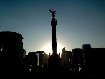 Low angle view of statue at sunset