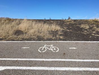 Text on road against clear sky