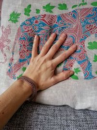 Cropped hand of person touching textile