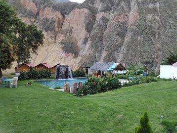 Houses by trees and mountains against sky