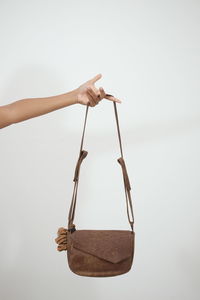 Person holding rope against white background