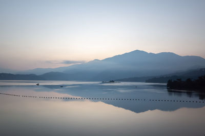 Scenic view of lake against sky during sunset