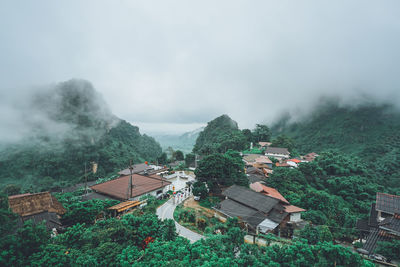 High angle view of houses and trees against sky