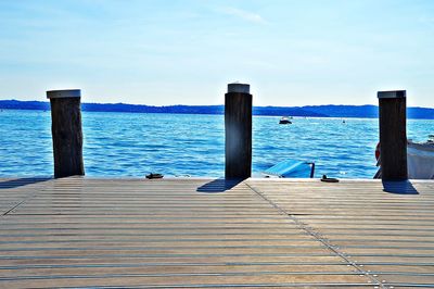 Pier over sea against blue sky