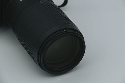 Close-up of camera on table against white background