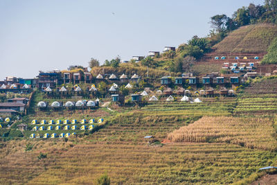 High angle view of houses on field against clear sky