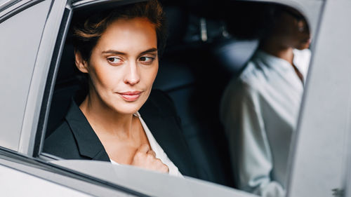 Portrait of a young woman in car