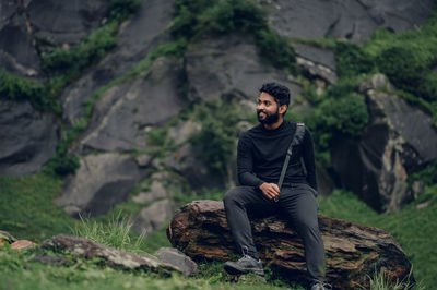 Portrait of man sitting on mountain