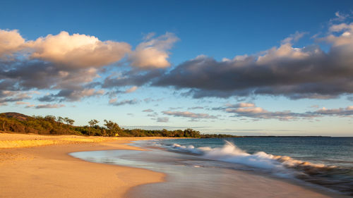 Scenic view of beach against sky during sunset