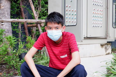 Portrait of a young man sitting outdoors