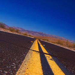 Surface level of road against clear sky