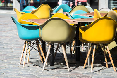 A summer street cafe in city center of tallin with multi colored plastic chairs as outdoor seating