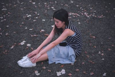 High angle view of woman stretching on field