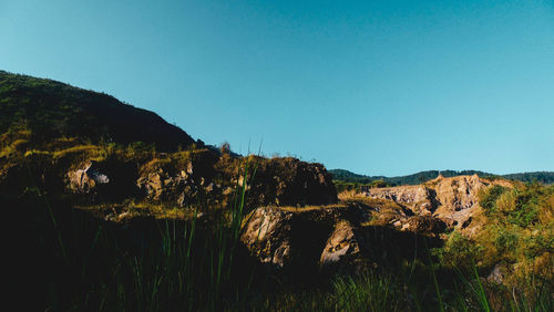Scenic view of rocky mountains against clear blue sky