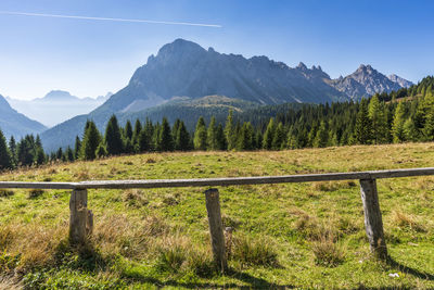 Scenic view of field and mountains against sky