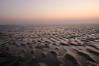 Scenic view of beach against sky during sunset