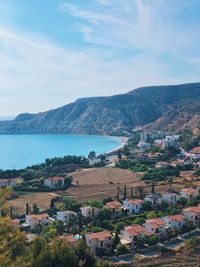 High angle view of townscape by sea against sky