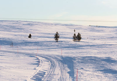 Scenic view of snow covered landscape against sky