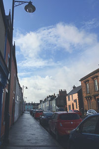 Street amidst buildings in city against sky