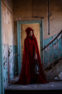 Full length of woman standing against building