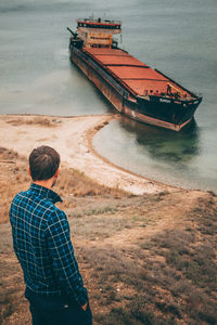 Rear view of man on boat in sea