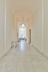 Rear view of man walking in corridor