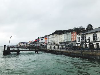 Scenic view of sea against sky in city