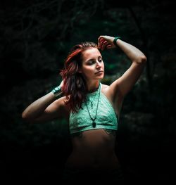 Beautiful young woman standing in a park