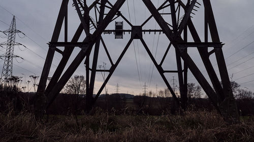 Low angle view of silhouette metal against sky