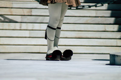 Low section of woman wearing canvas shoes